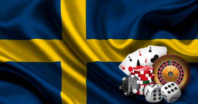 Ruotsin lippu, noppia, kortteja, pelimerkkejä ja rulettipyörä